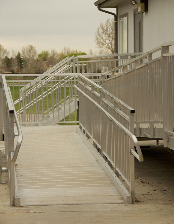 Image of outdoor aluminum wheelchair ramp beside building