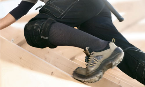 man doing construction with medi compression socks